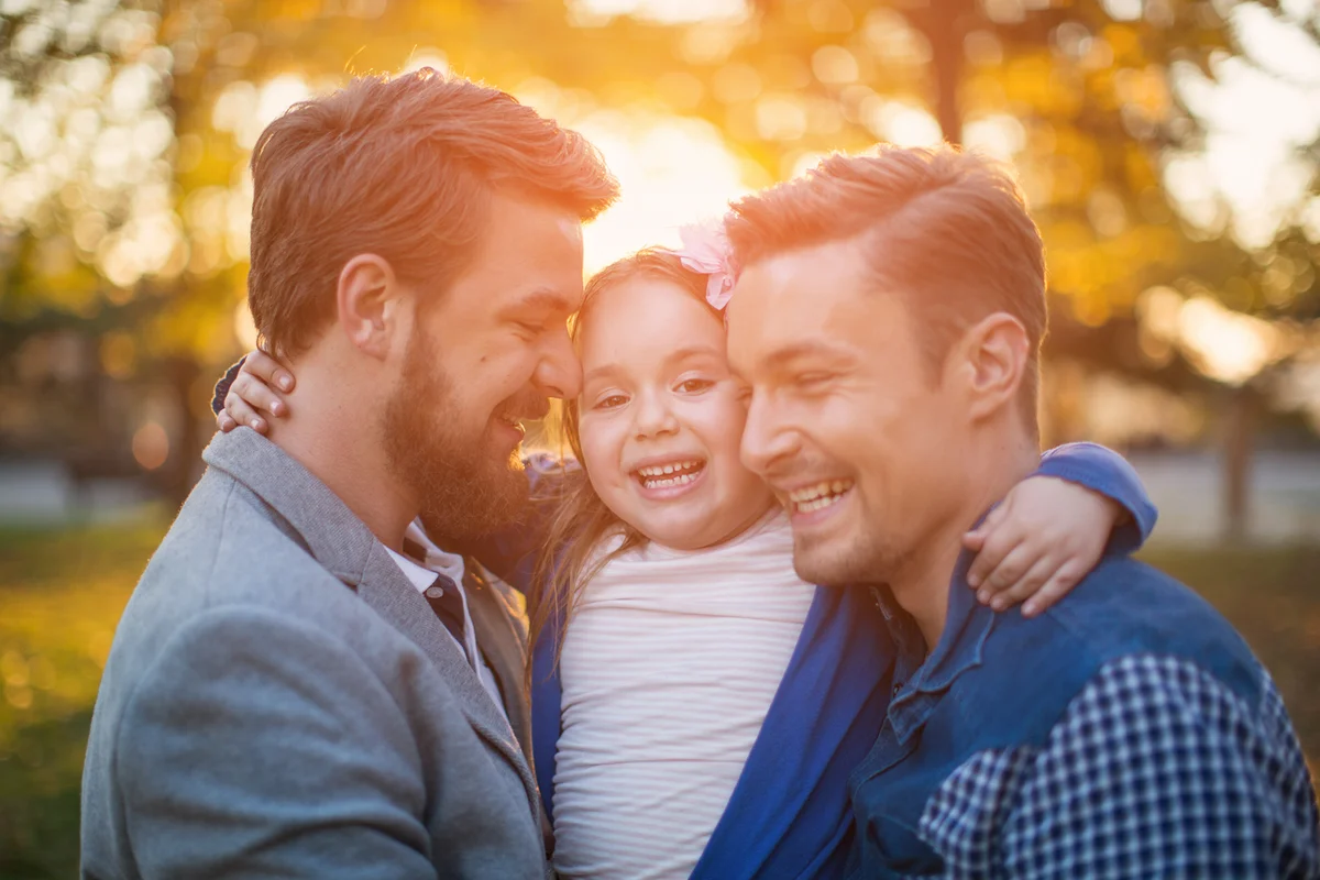 parents with their daughter having fun in park