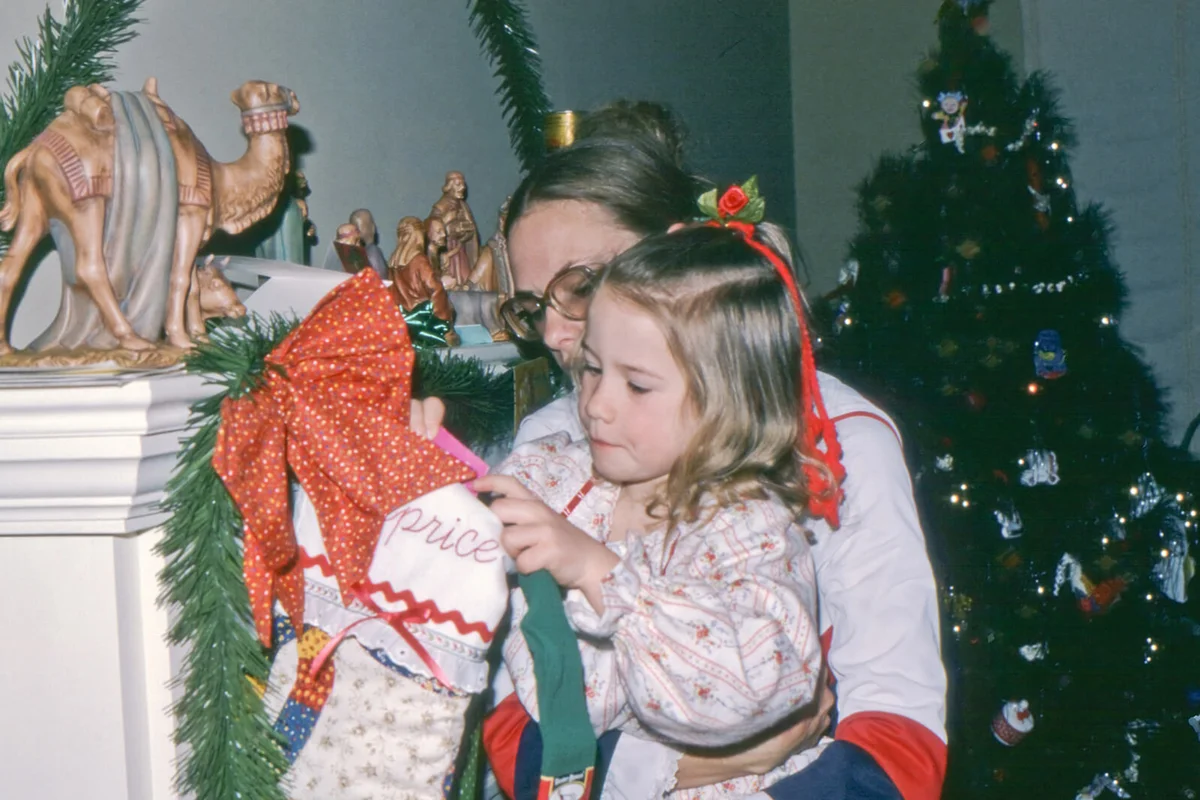 Mom helps daughter reach Christmas stocking