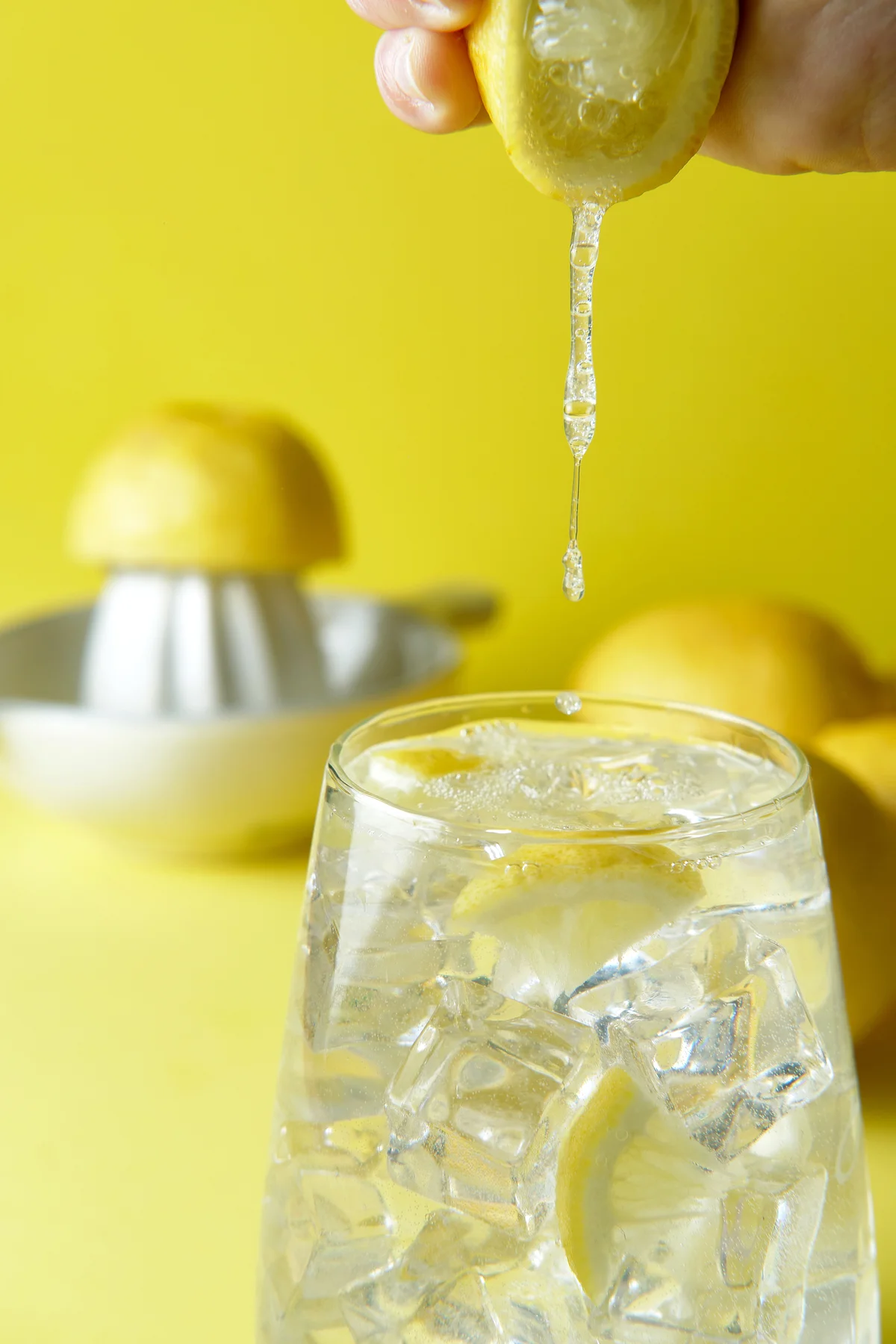 Squeezing lemon in a glass