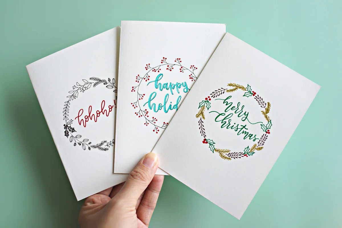 Hand Holding Christmas Cards