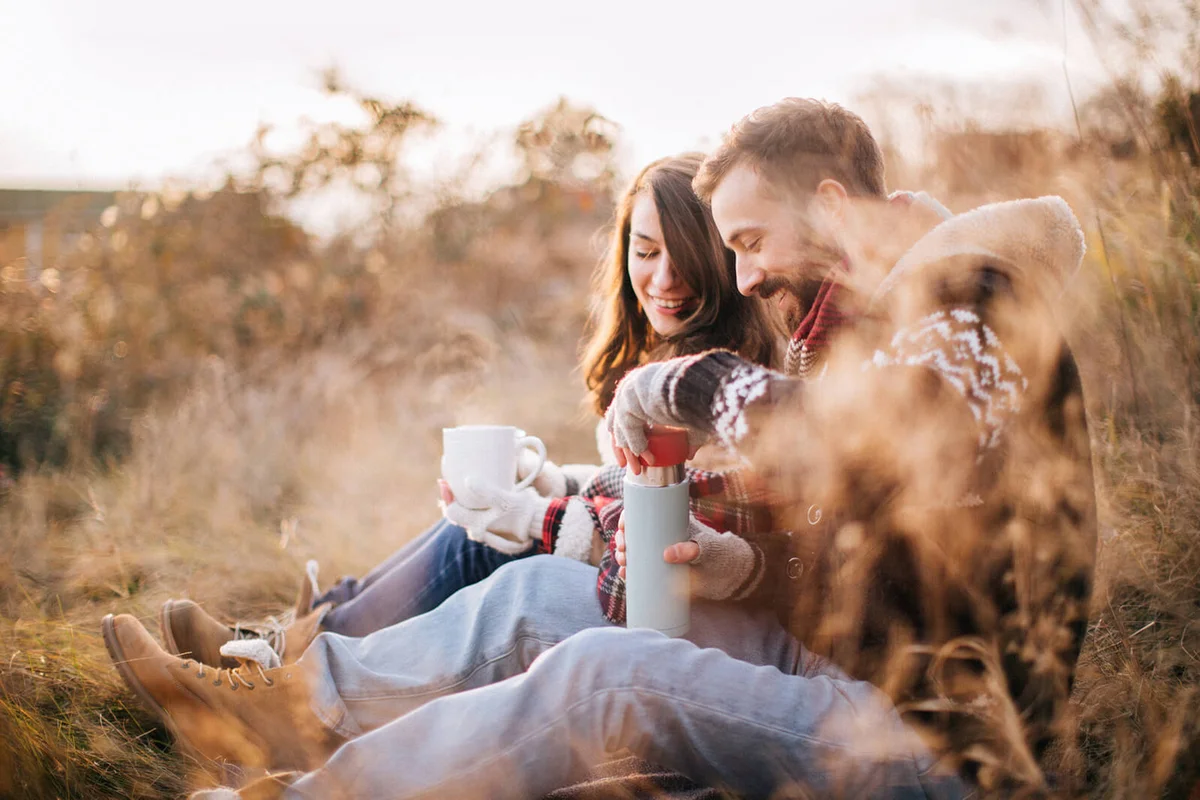 Portrait of loving couple enjoying cold autumn days in nature
