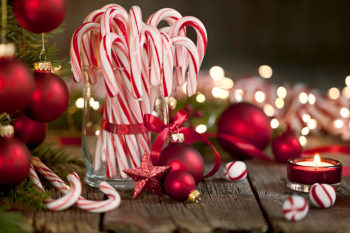 Candy Canes and Bright Christmas Lights on an Old Wood Background