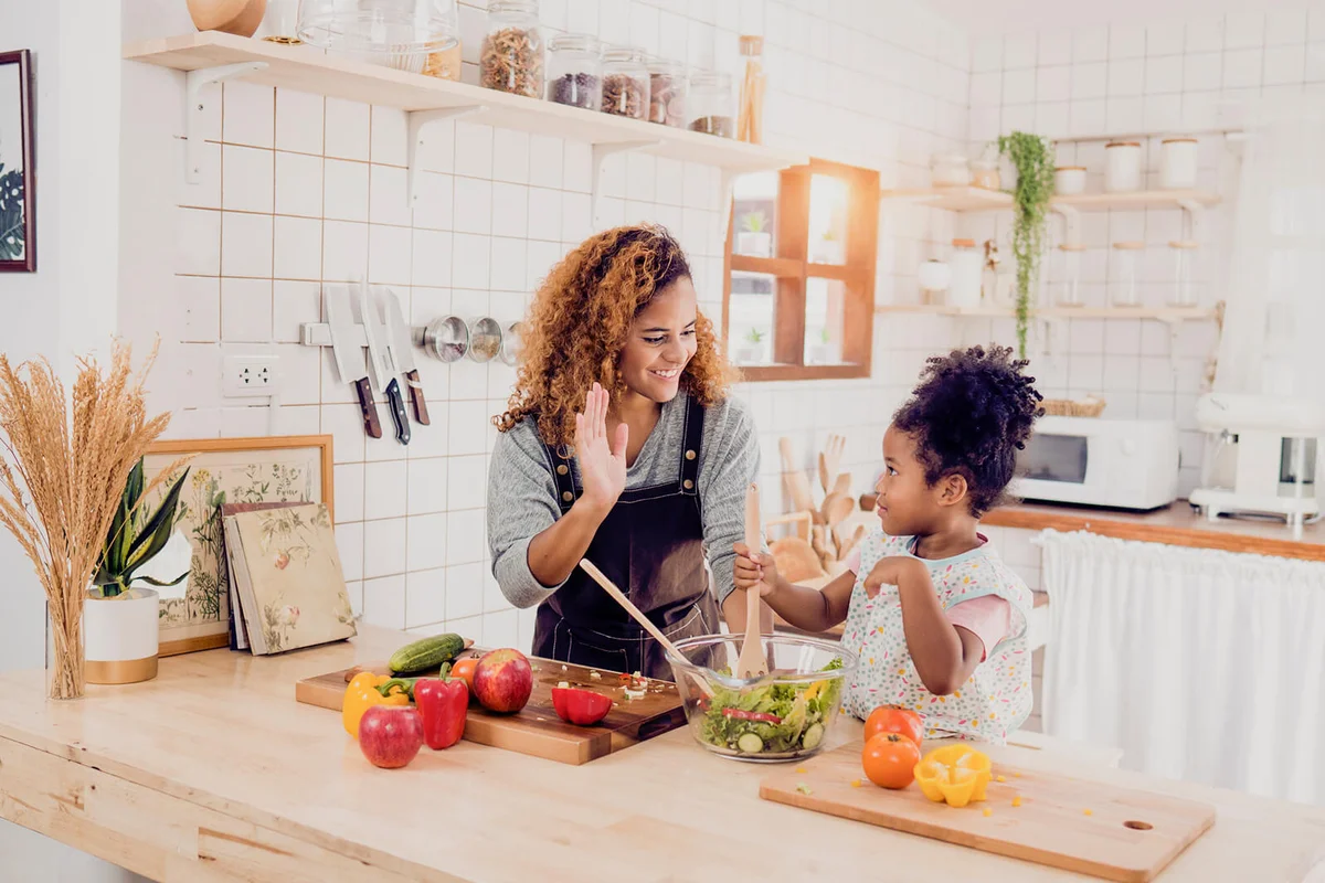 Mother and daughter having fun with the vegetables