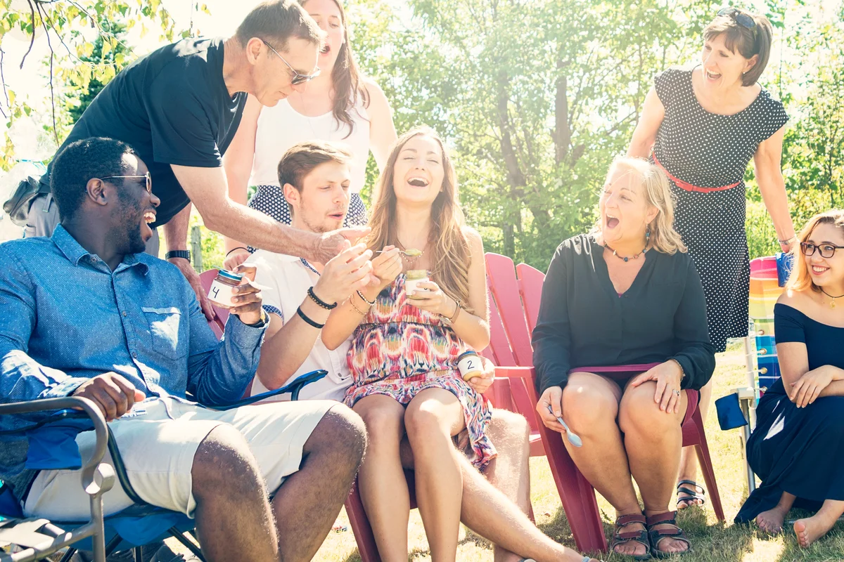 Parents tasting baby food at shower party in summer