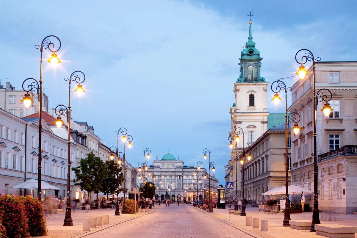 Holy Cross Church and Academy of Sciences in Krakowskie Przedmiescie street at dusk