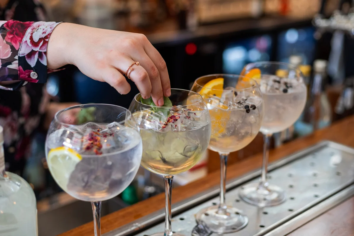 Garnish being placed in a gin cocktail