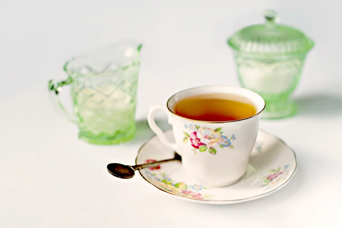 Cup of black Earl Grey tea in an antique floral cup