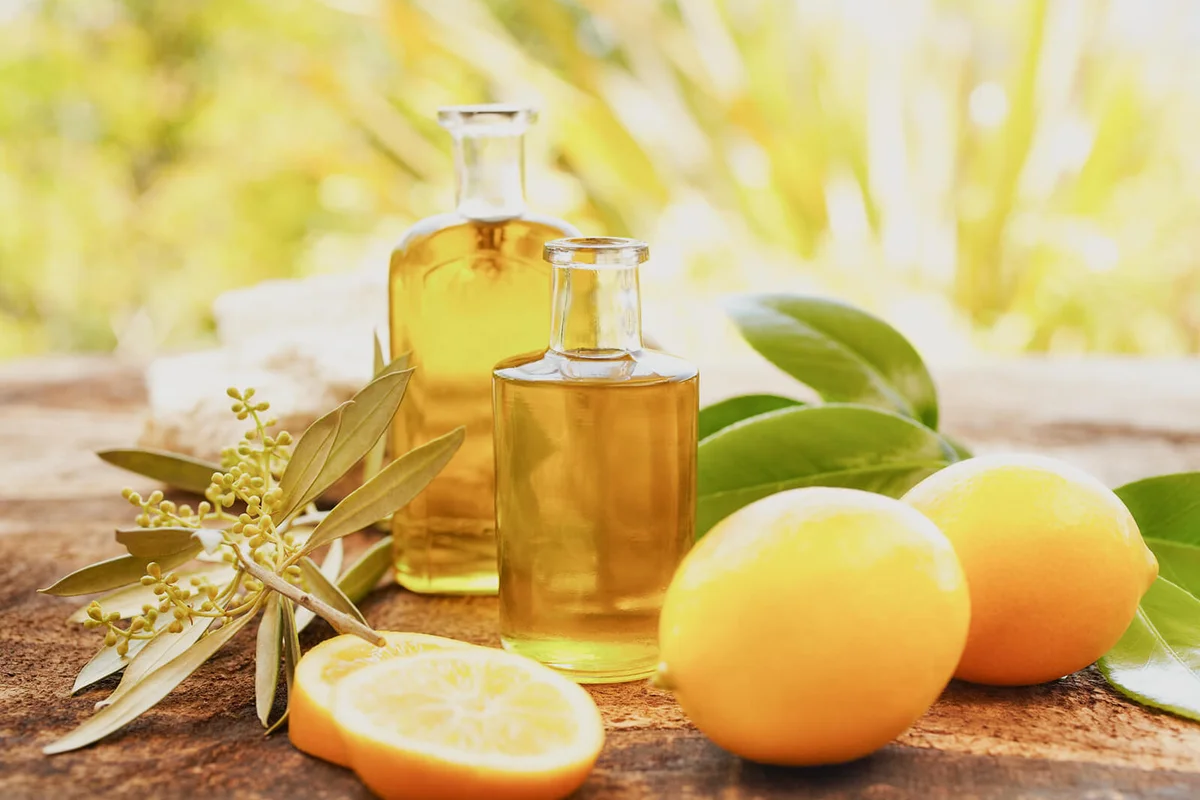 Massage oil bottles at spa outdoors with lemons