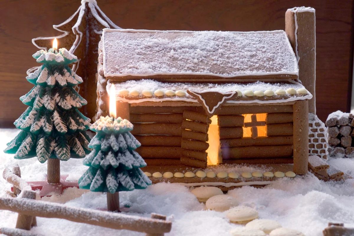 Gingerbread log cabin in snowy forest