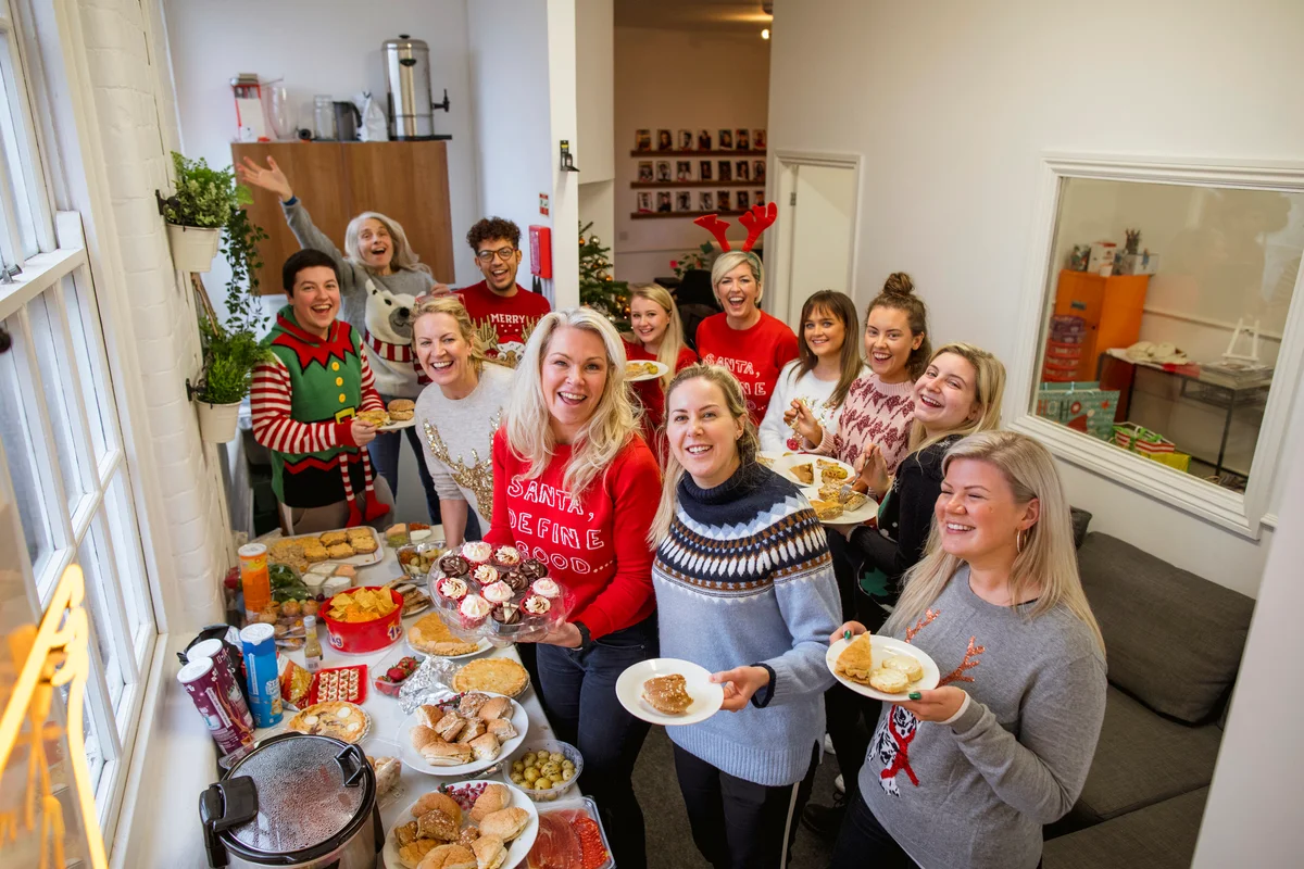 People enjoying and eating at Christmas party