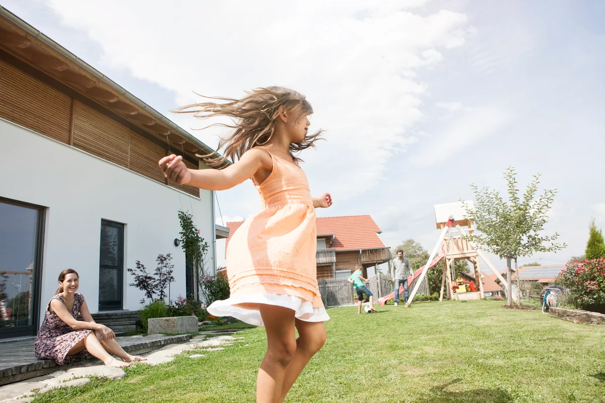 Playful girl with family in garden