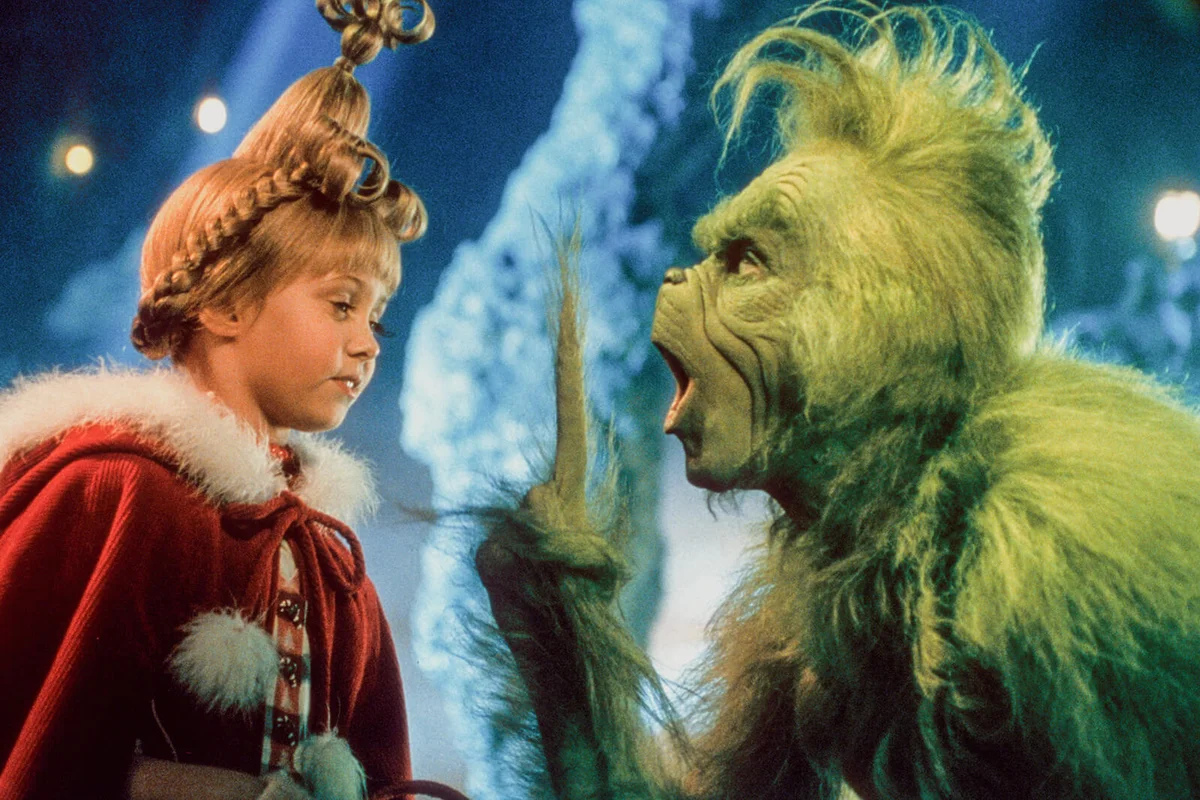 Taylor Momsen listening to Jim Carrey in a scene from the film 'How The Grinch Stole Christmas', 2000 | Getty Editorial Use
