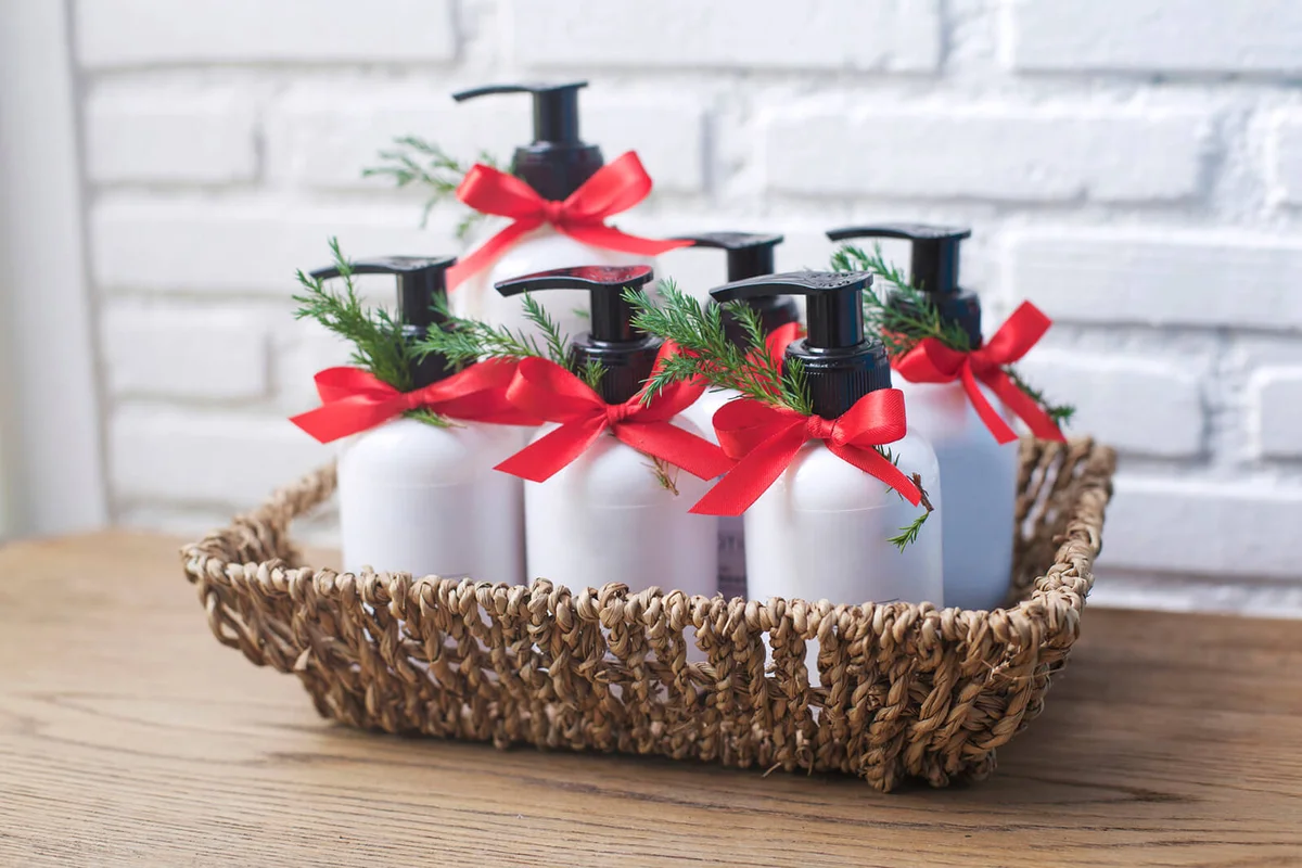 Soap Dispensers In Wicker Basket On Table
