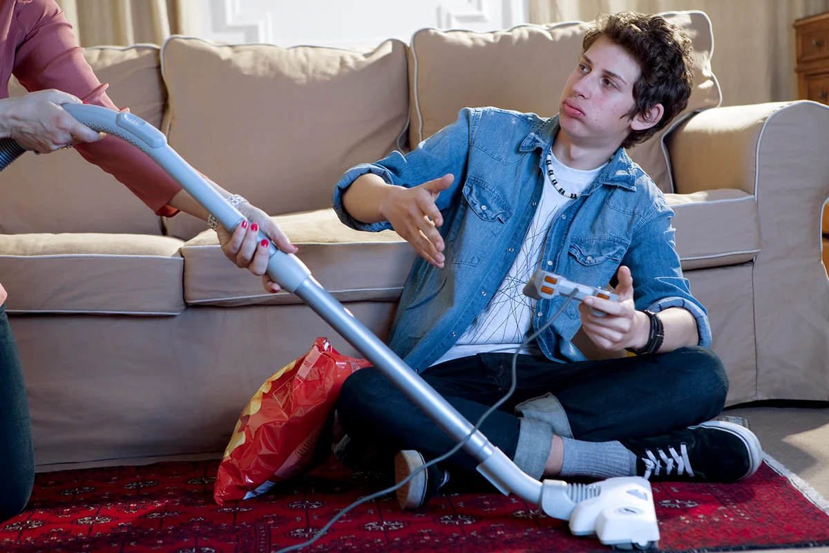 A boy's gaming interrupted by his mum's vacuuming