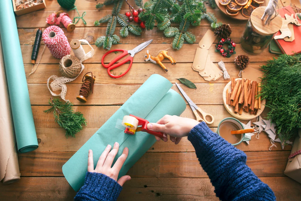 Woman's hands wrapping christmas gifts