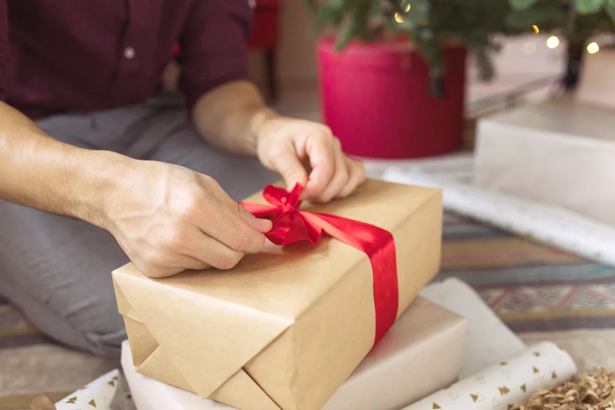 Man Wrapping Christmas Present