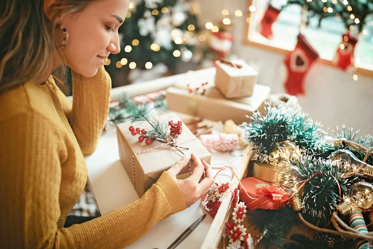 Women wrapping Christmas gifts at home