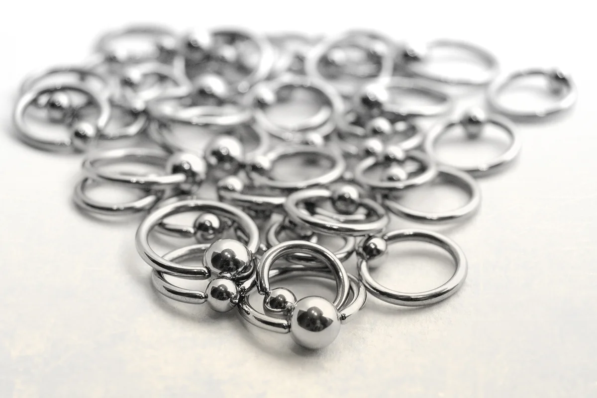 Close-up of scattered stainless circulars with beads