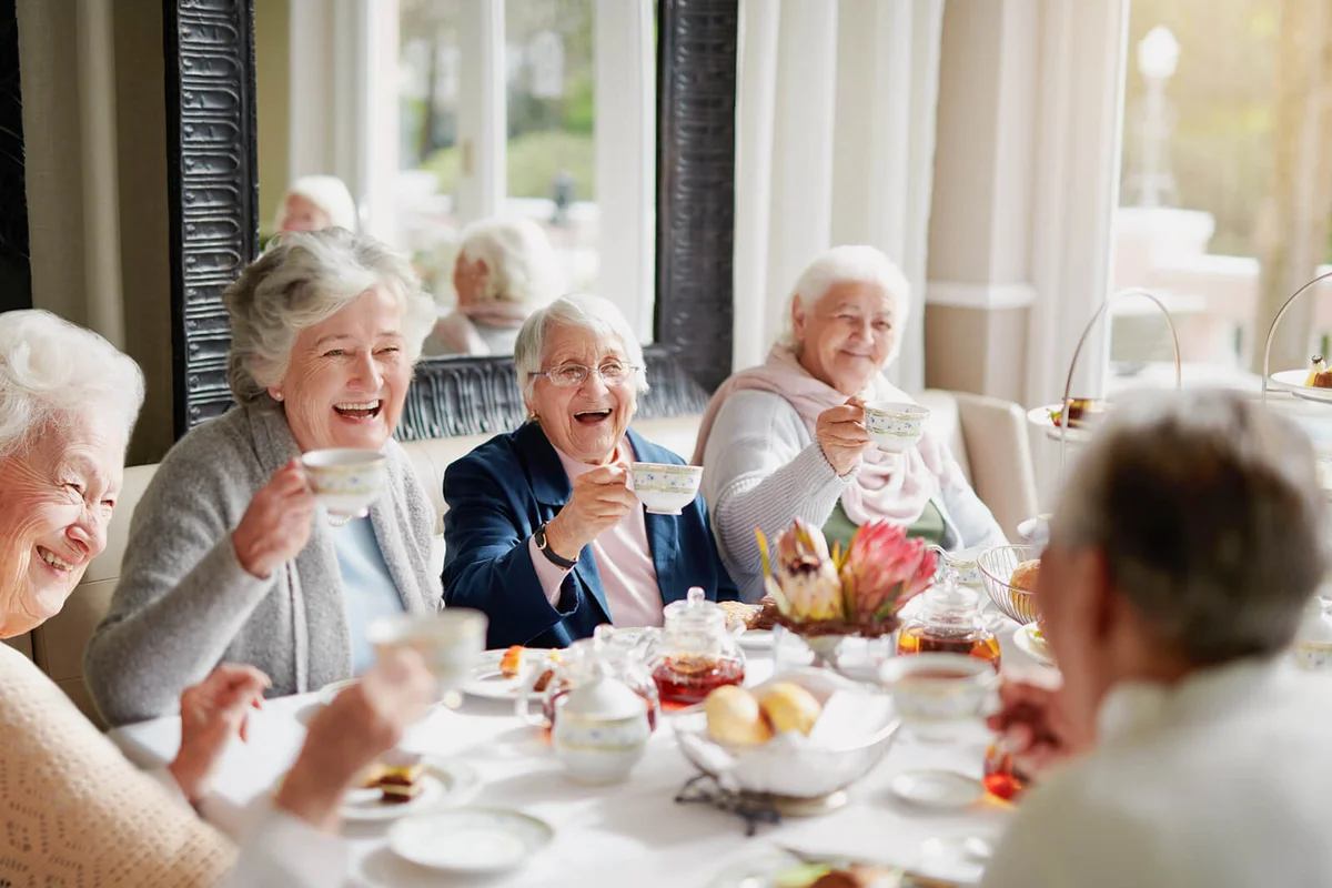 group of seniors having tea in their retirement home