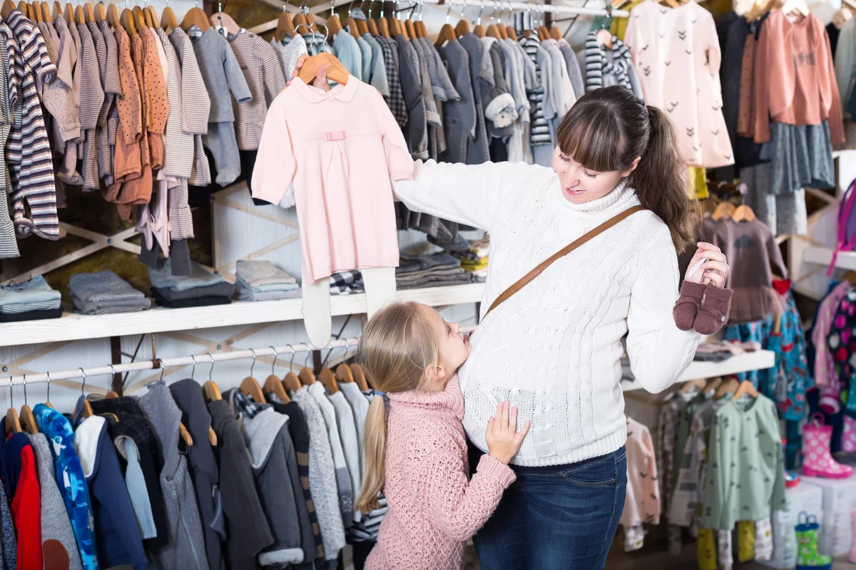 Family chooses clothes for newborns