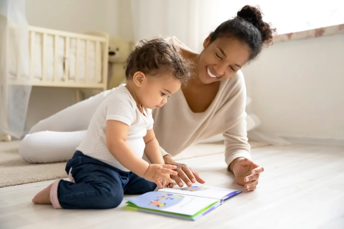 Mom reading book with little baby