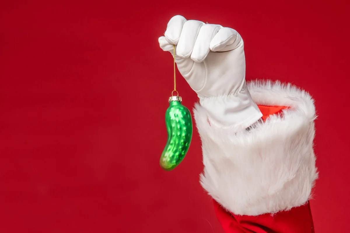 Santa Claus eating Christmas pickle decoration
