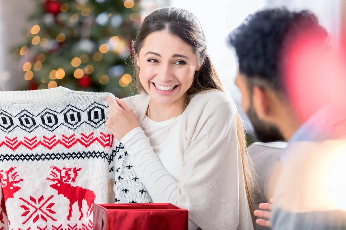 Young woman shows disappointment in Christmas gift