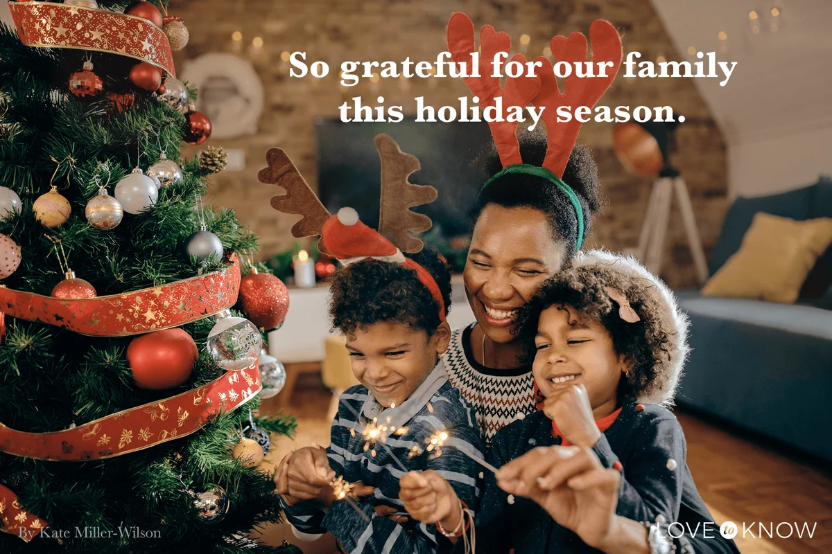 Joyful family celebrating Christmas and having fun with sparklers at home