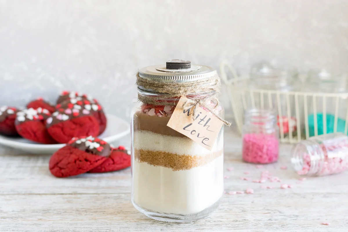 A mixture of ingredients for baking cookies in a gift jar
