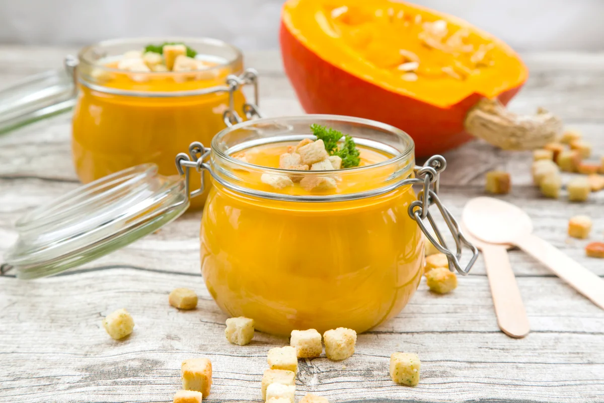 Pumpkin soup with croutons, garnished with parsley in jar