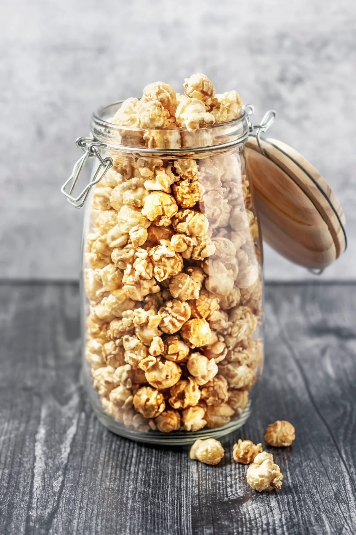 A jar of popcorn on gray background