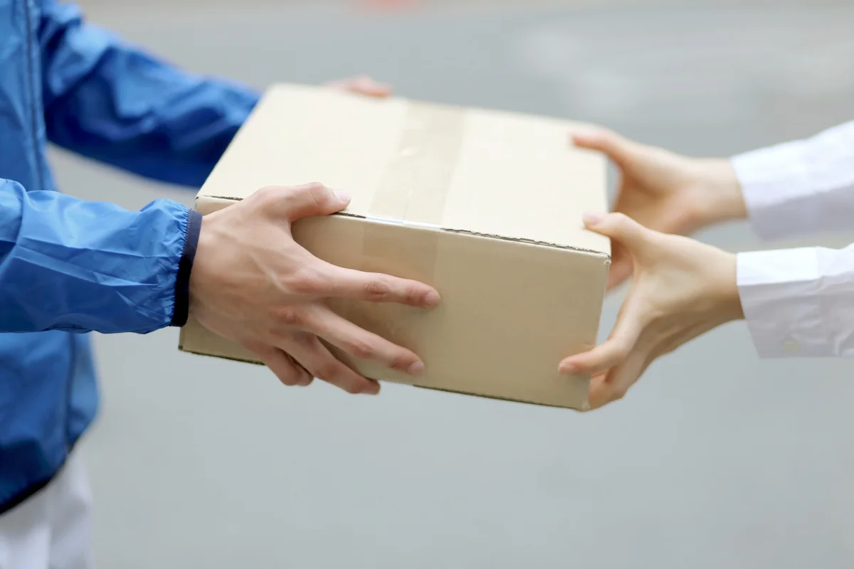 Two people holding a box