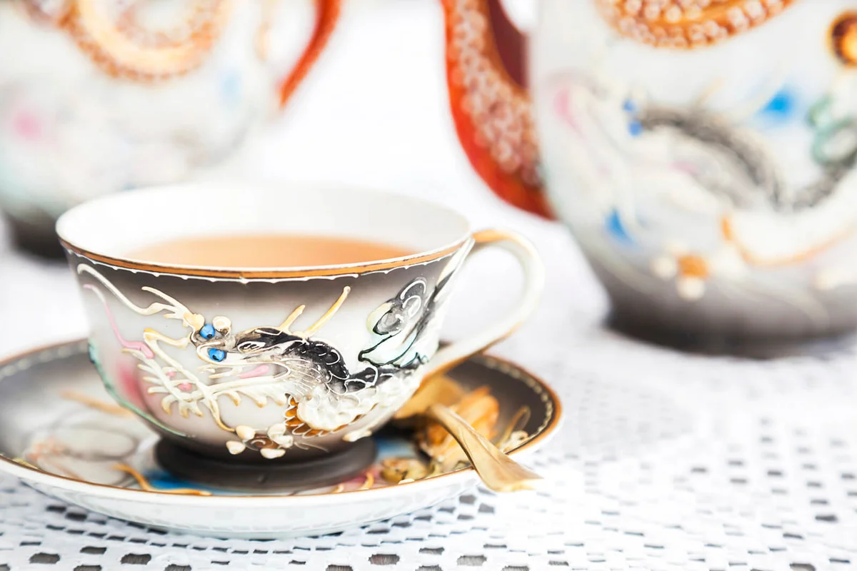 Elegant teacup with dragon design in moriage technique