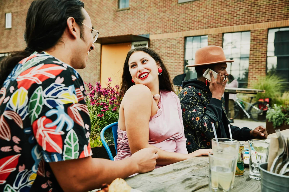 Smiling woman in discussion with boyfriend during party