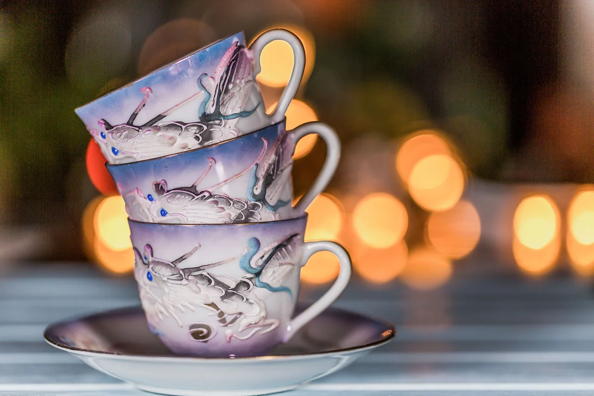 Vintage Japanese Tea Cups and Saucer on Wood table with light background