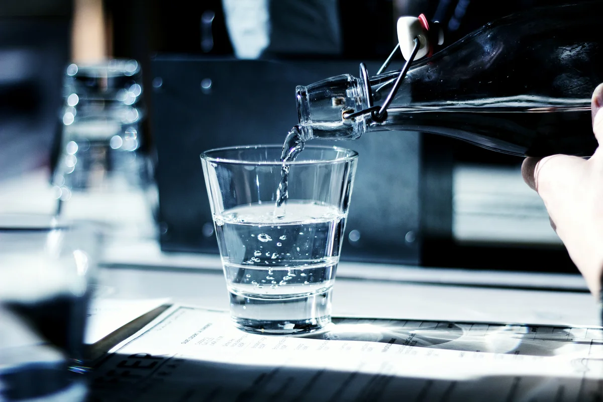 Gin Being Poured In Glass On Table