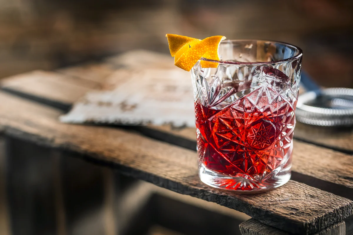 Cocktail Negroni on an old wooden board