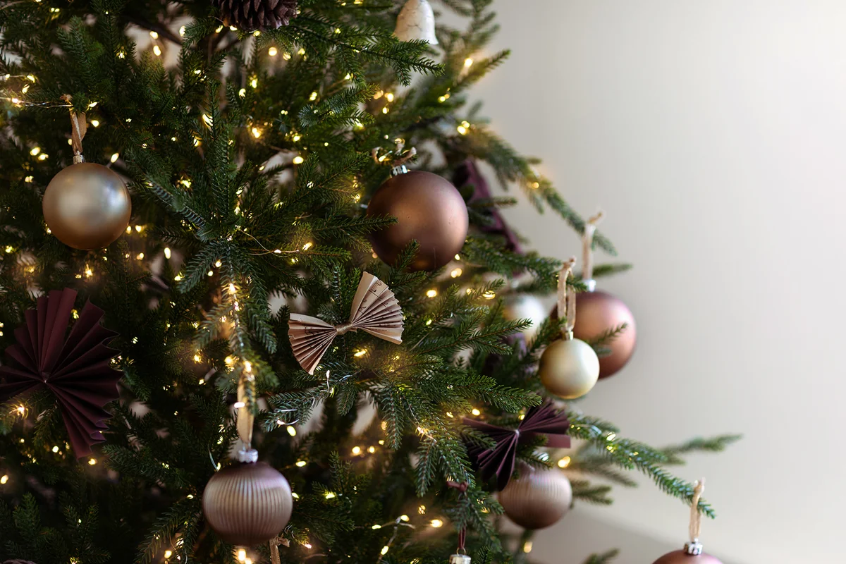 festively decorated Christmas tree with pastel brown balls and ornaments