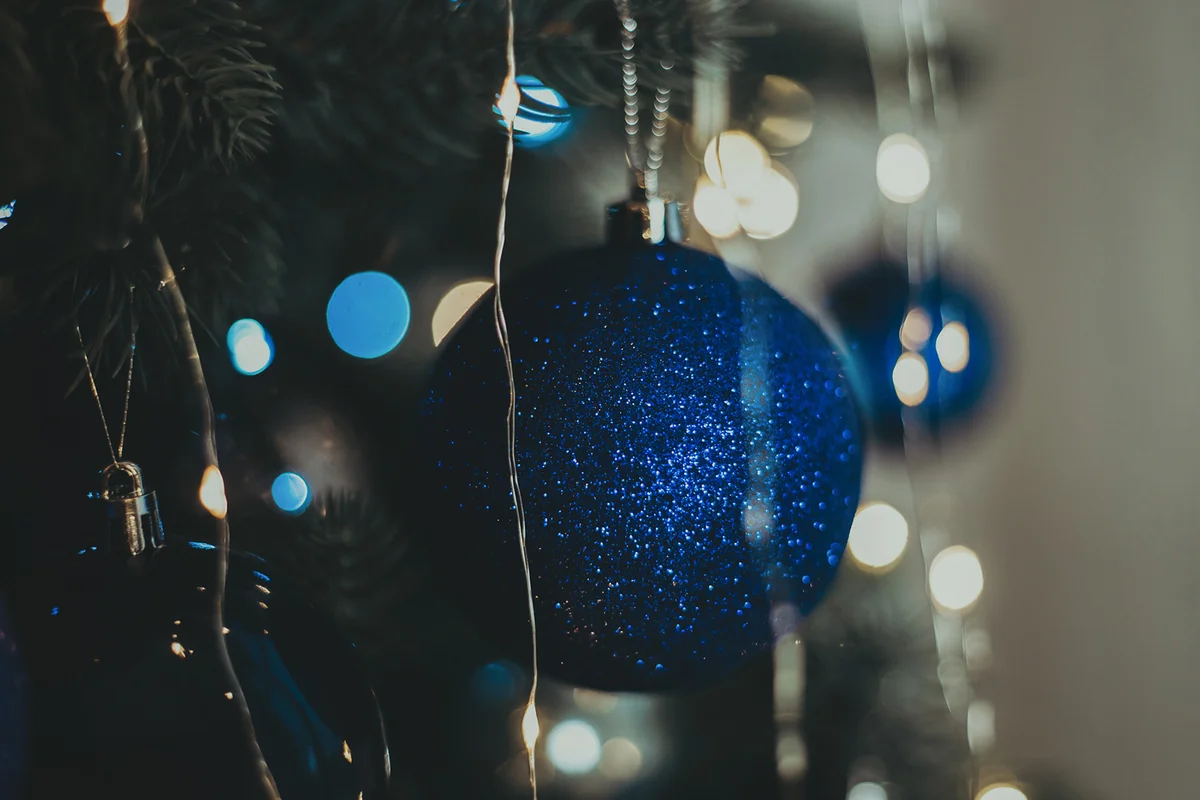 Beautiful sapphire blue Christmas toy on a bright Christmas tree