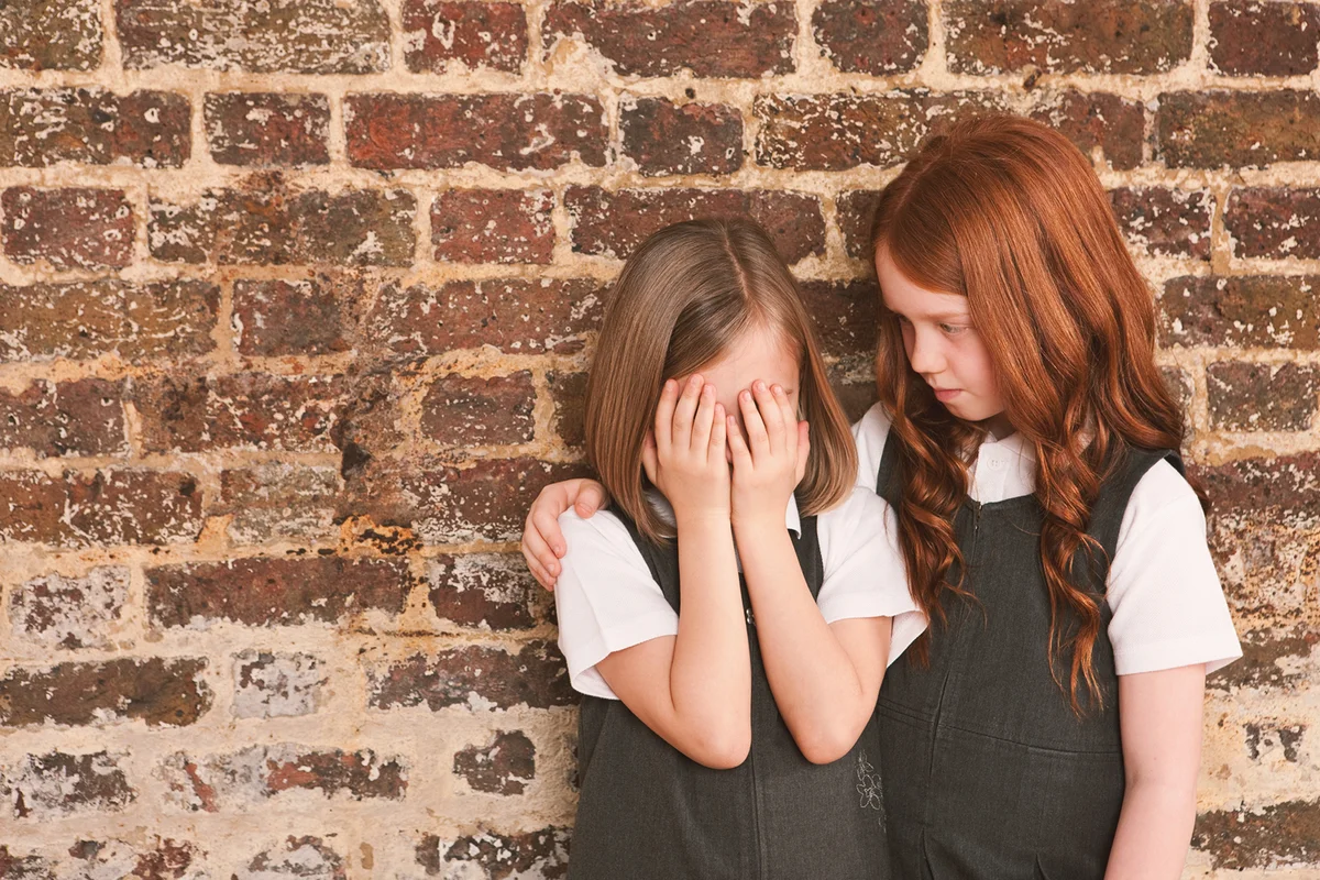 Girl comforting her friend