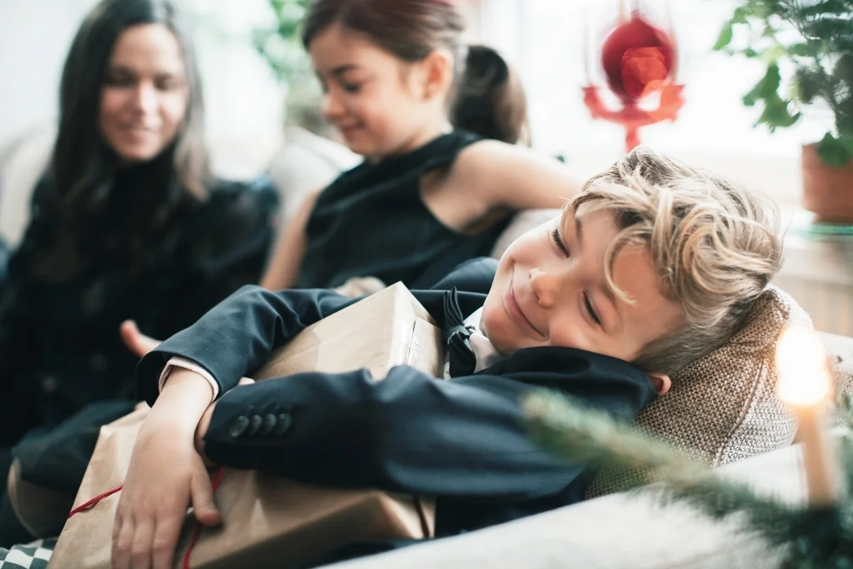 Smiling boy holding Christmas present