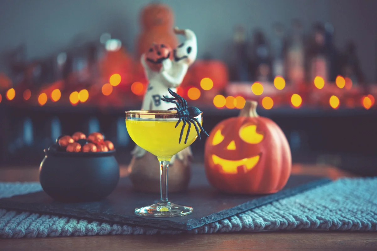 Vibrant colored drink with cauldron of candy