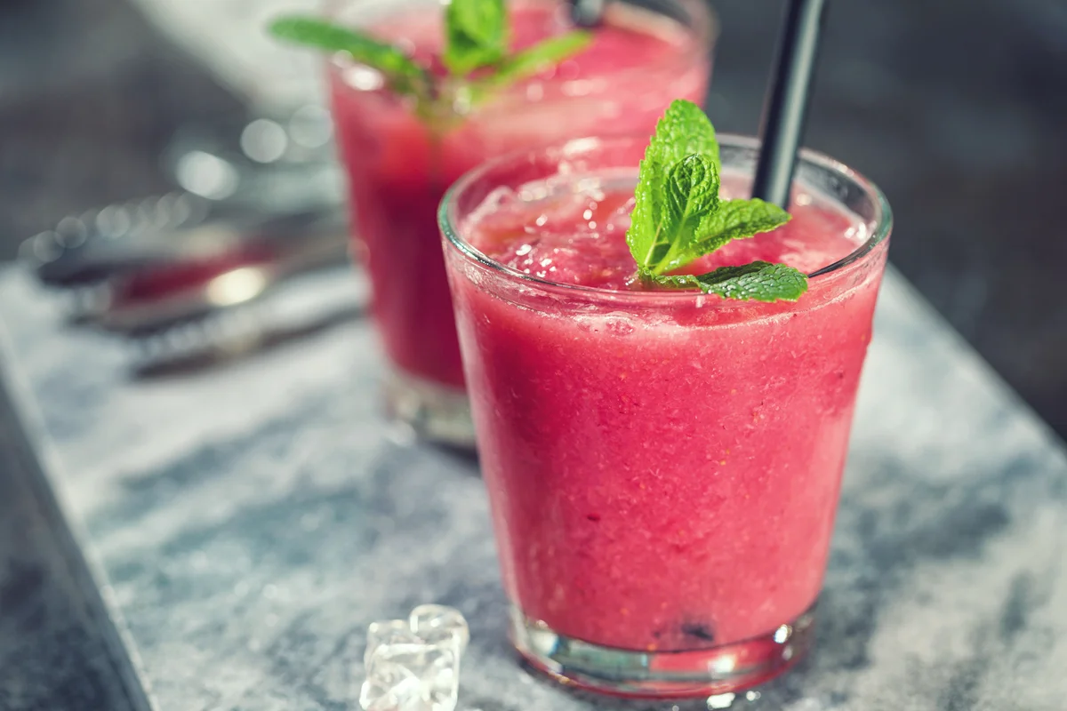Freshly made watermelon martini with ice and mint leaves