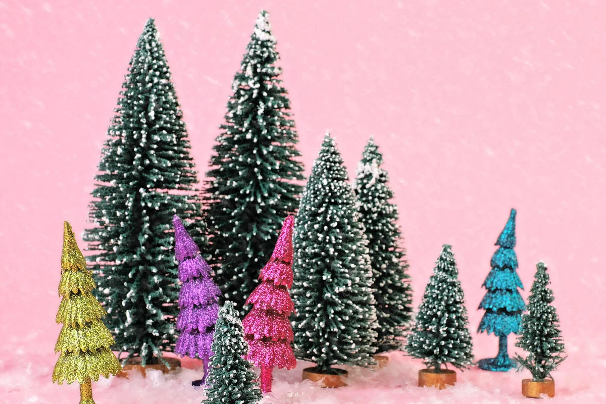 Tiny trees on pink background with snow