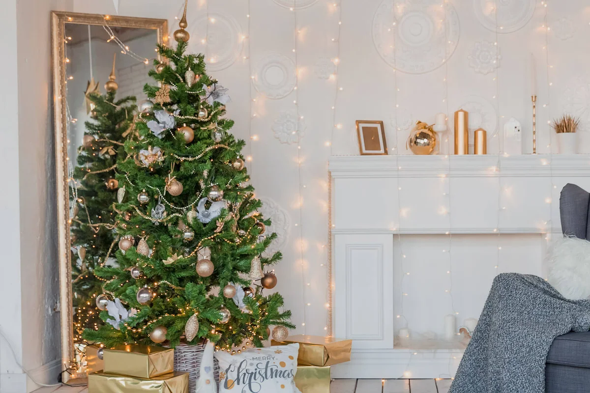 Modern design room in light colors decorated with Christmas tree and decorative elements