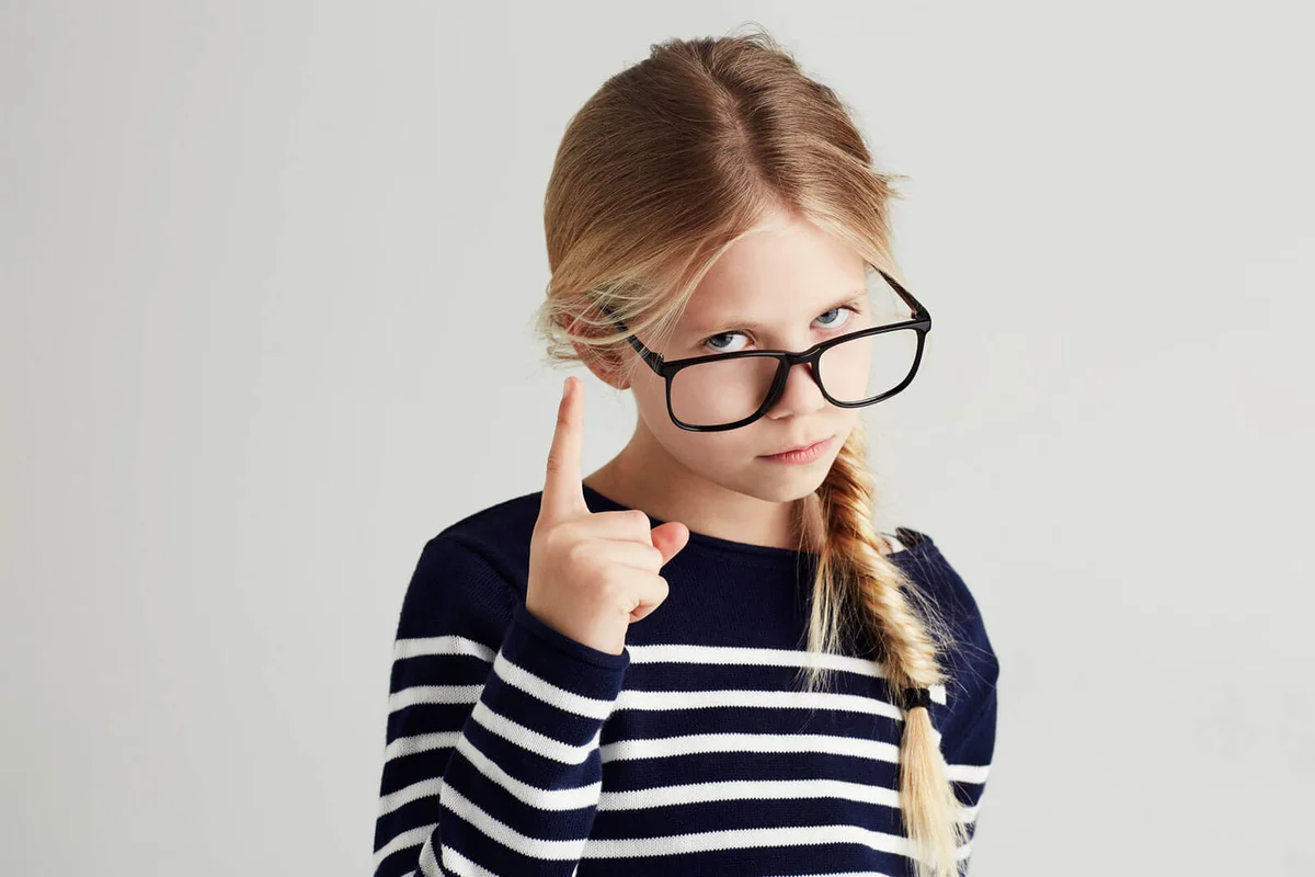Portrait of a cute girl gesturing seriously toward you