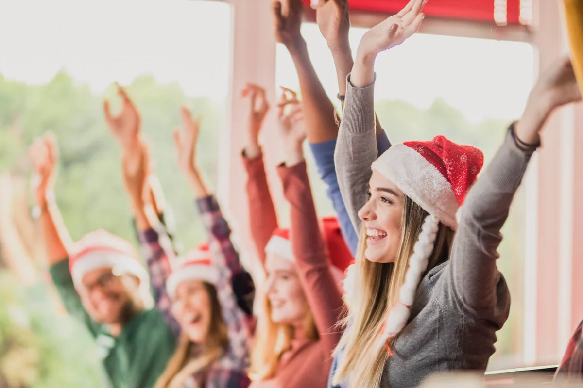 Large group of happy students celebrating New Year in the classroom