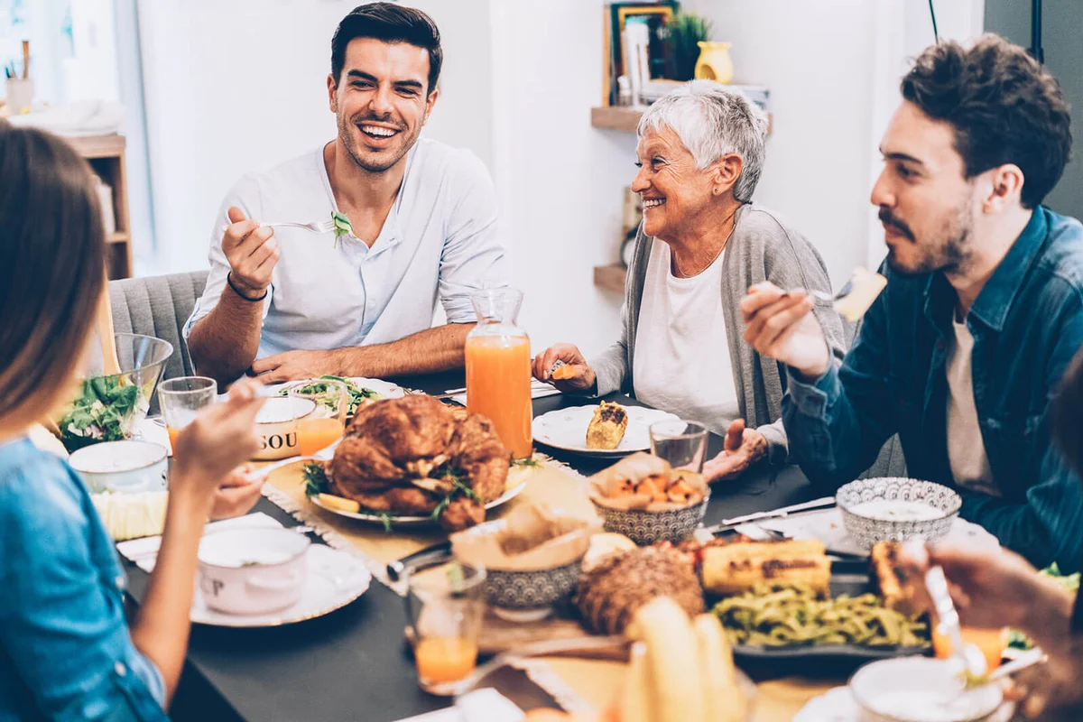 Happy family eating roasted turkey