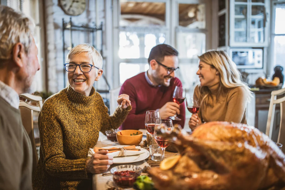 woman talking to her husband during Thanksgiving family's lunch at home