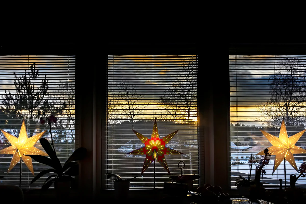 Lighted Christmas stars by the window